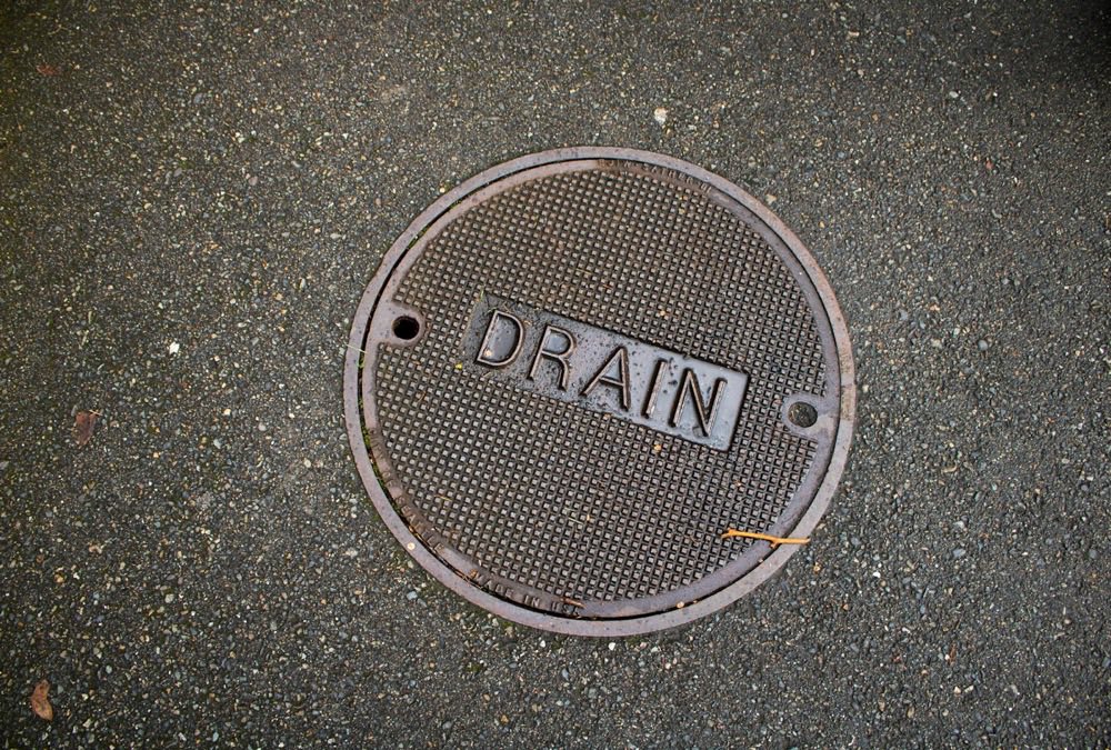 A drain cover in the pavement