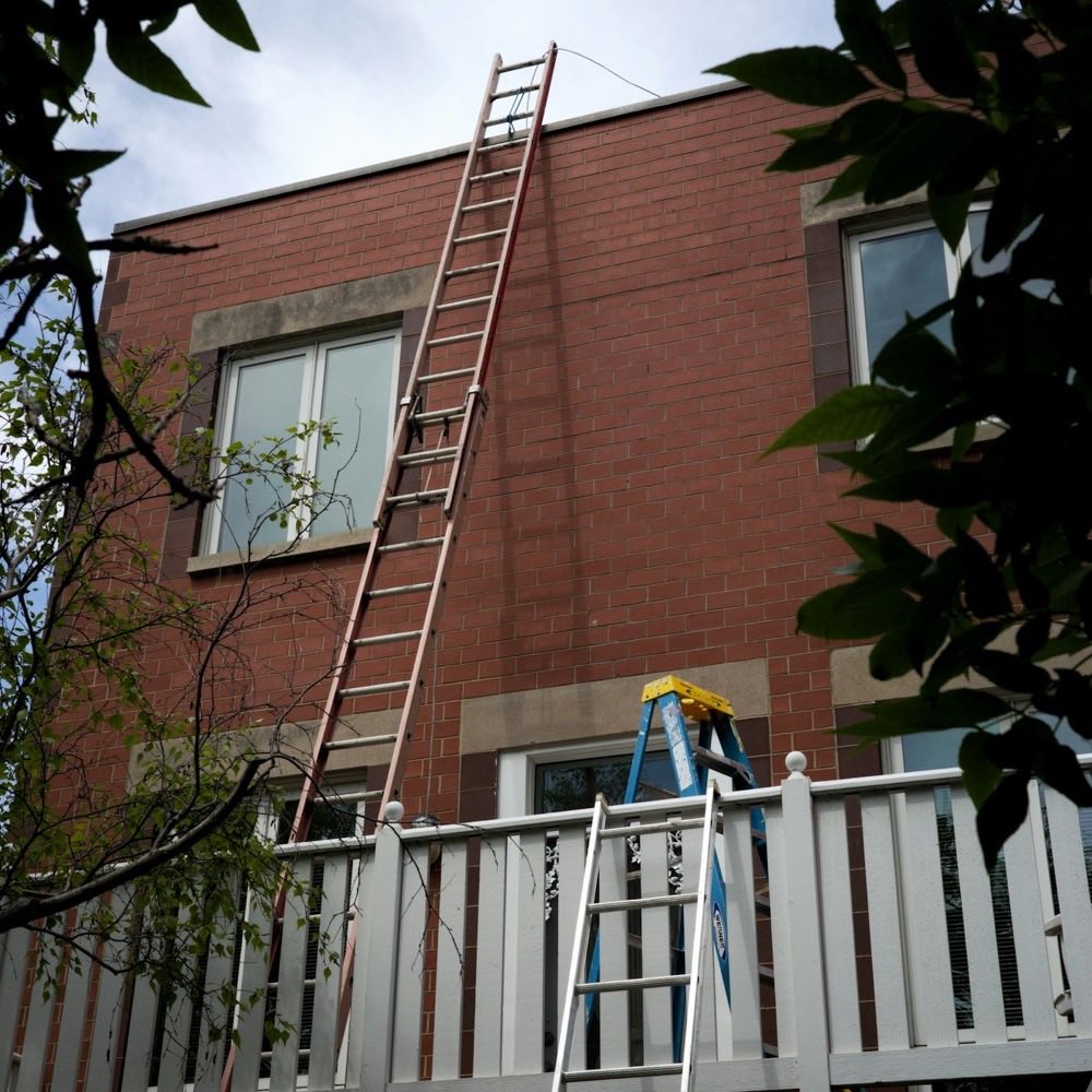 Ladders against a brick house during building work