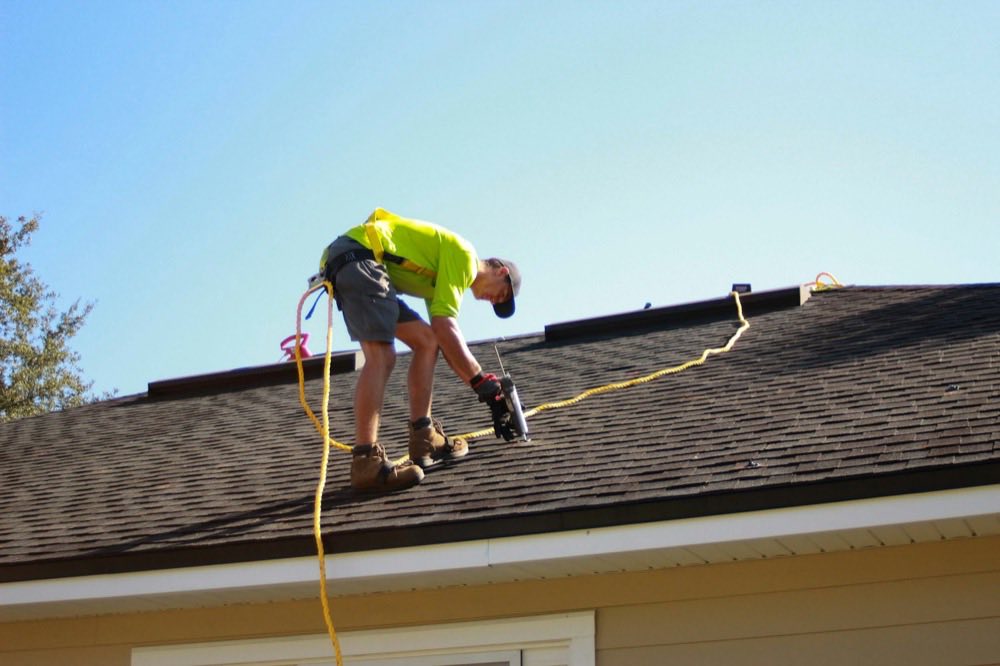A roofer working on a pitched roof