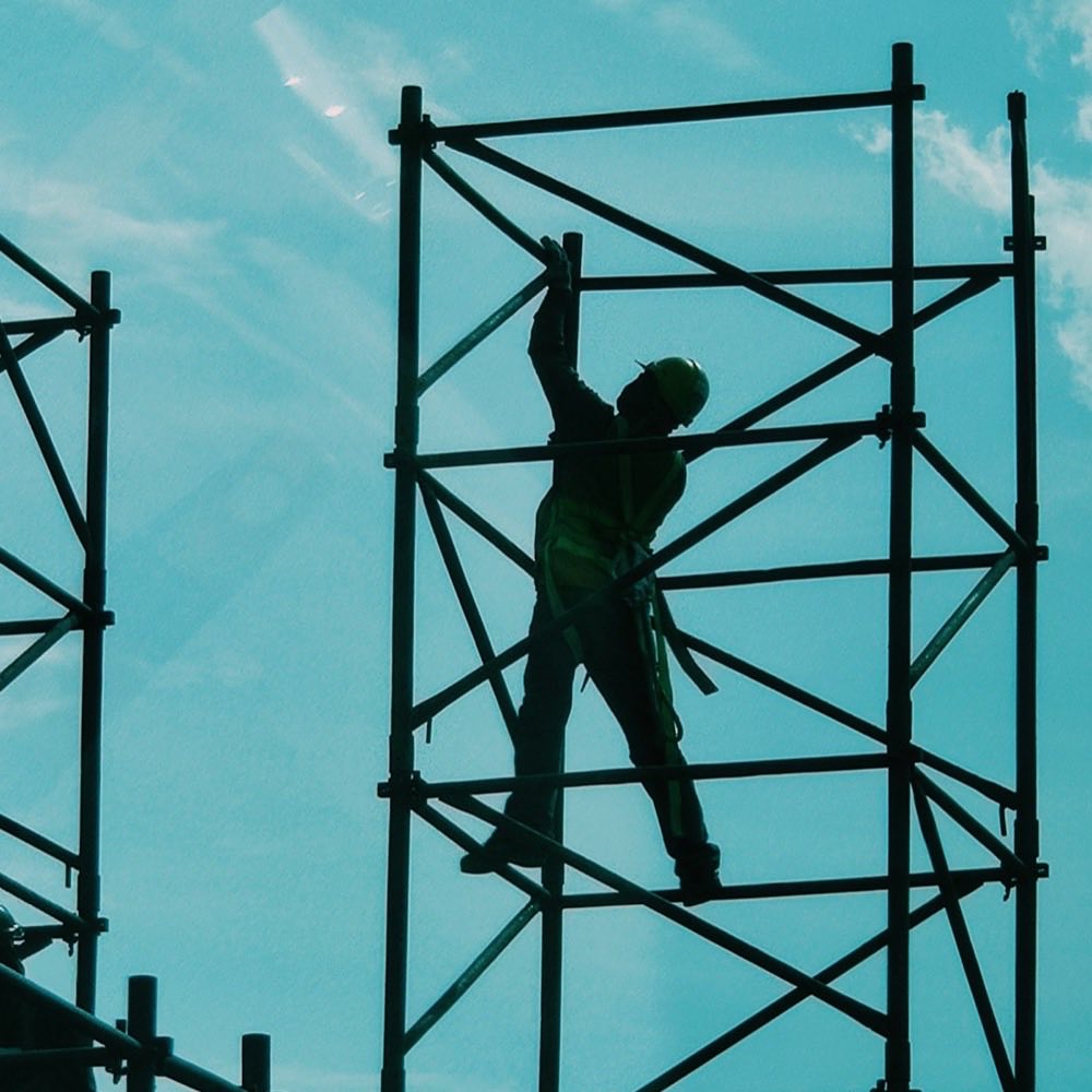 A scaffolder standing on a scaffold frame
